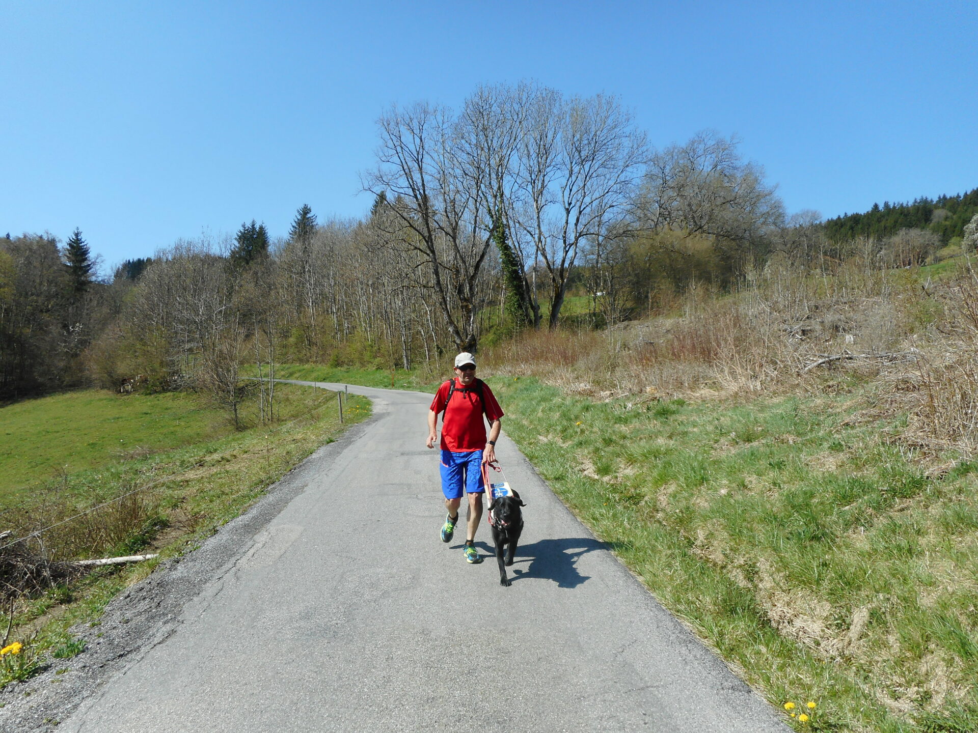 Elie et Jinga cheminent ensemble dans la nature Elie porte un t-shirt rouge